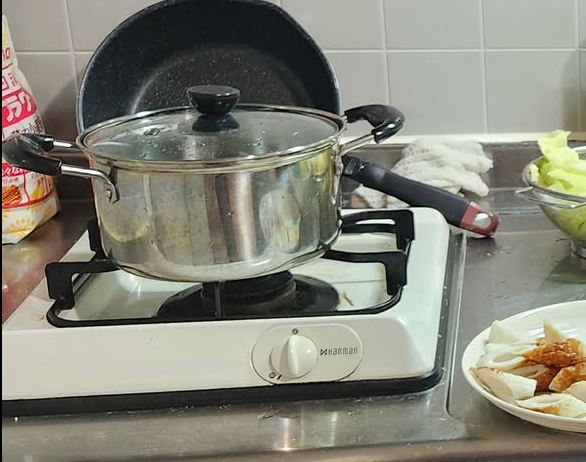 Old gas stove with a pot